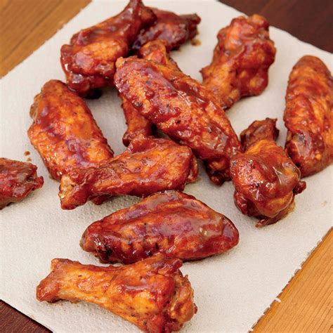 Whiskey wings - Directions: Preheat oven to 450°. Line baking sheet with aluminum foil and place a cooking rack on top. In a large bowl, toss the wing pieces with the baking powder, garlic powder, and black pepper until evenly coated. Arrange the pieces on the cooking rack about an inch apart. Bake for 25 minutes on each side.